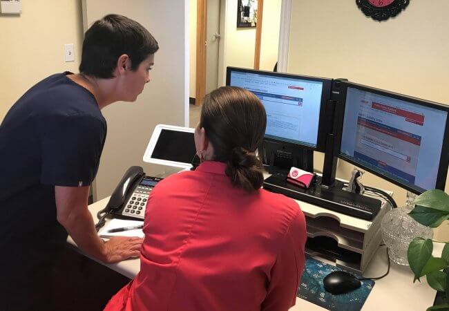 Danielle H. Pendergrass and assistant look at the AARP Livability Index in her office.