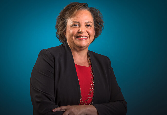 Charlotte Parent headshot. Black jacket and red shirt